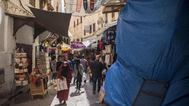 Tourists and locals walk in walled medina. Behind the high crenellated walls that surround the medina lie 9,000 historical houses, 11 madarsas, 83 mausoleums, 176 mosques and 1,200 handicraft workshops. Patrician palaces with their secret gardens and terraces, elegant fountains and ancient caravansary, or inns, are among the jewels lying there to be discovered. (Fadel Senna / AFP)