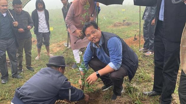 Meghalaya Chief Minister Conrad Sangma plants a sapling at Langkyrdem village. Meghalaya planted 1.5 million saplings in 306 springsheds across all the 11 districts of the state to mark the World Environment Day. In all, 460 villages across the 46 community and rural development blocks planted 1,000 saplings each. Besides this, a million saplings were planted in spring sheds and catchment areas across the state. (HT Photo)