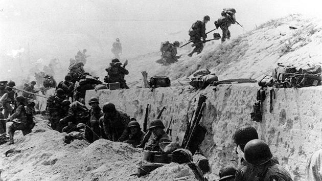 US Army soldiers of the 8th Infantry Regiment, 4th Infantry Division, move out over the seawall on Utah Beach after coming ashore on June 6, 1944. Among the Allied troops on D-Day, 73,000 were from the United States, 83,000 from Britain and Canada. They faced some 50,000 German forces. (US National Archives / Army Signal Corps Collection via REUTERS)