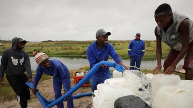 Residents fill up a containers with water from a polluted river as the city's water crisis mounts near Cape Town, South Africa, February 2, 2018. REUTERS/Mike Hutchings (Reuters File Photo) Residents fill up a containers with water from a polluted river as the city's water crisis mounts near Cape Town, South Africa, February 2, 2018. REUTERS/Mike Hutchings (Reuters File Photo)