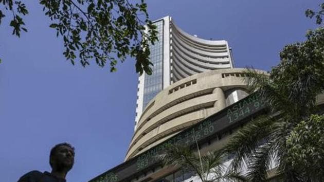 A pedestrian walks past an electronic ticker board indicating latest figures for the S&P BSE Sensex at the Bombay Stock Exchange (BSE) building in Mumbai. Image used for representational purpose only. (Bloomberg/ File photo) A pedestrian walks past an electronic ticker board indicating latest figures for the S&P BSE Sensex at the Bombay Stock Exchange (BSE) building in Mumbai. Image used for representational purpose only. (Bloomberg/ File photo)