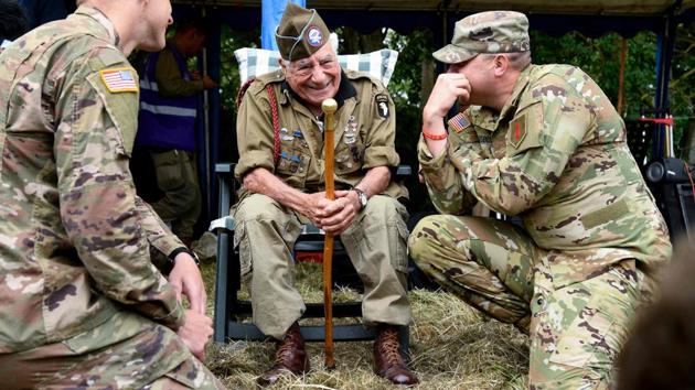US veteran paratrooper Vincent Speranza speaks with a US soldier. American attendee Richard Clapp said it was sobering to admire the “beautiful sunrise” where Allied troops came ashore. Meanwhile, Norwegian Sigrid Flaata drove from Oslo in a 1942 restored jeep to honour the soldiers who died on D-Day and Belgian Filip Van Hecke called his journey a “small effort to pay homage.” (Bertrand Guay / AFP)
