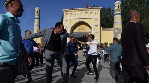 Men dance after the Eid-ul-Fitr prayers at Idkah mosque. Uighurs consider mosques and shrines “their ancestral heritage,” said Omer Kanat, director of the Uyghur Human Rights Project. “The Chinese government just wants to erase everything... that is different from Han Chinese, everything which belongs to Uighur culture or Islamic culture in the region,” he added. (Greg Baker / AFP) Men dance after the Eid-ul-Fitr prayers at Idkah mosque. Uighurs consider mosques and shrines “their ancestral heritage,” said Omer Kanat, director of the Uyghur Human Rights Project. “The Chinese government just wants to erase everything... that is different from Han Chinese, everything which belongs to Uighur culture or Islamic culture in the region,” he added. (Greg Baker / AFP)