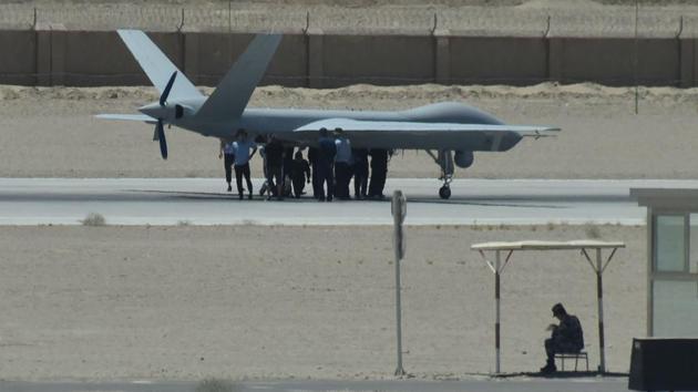 Personnel around a surveillance drone on the runway of the airport in Urumqi, Xinjiang. After initially denying their existence, Chinese authorities last year acknowledged that they run “vocational education centres” aimed at steering people clear of religious extremism by teaching them Mandarin and China’s laws. (Greg Baker / AFP) Personnel around a surveillance drone on the runway of the airport in Urumqi, Xinjiang. After initially denying their existence, Chinese authorities last year acknowledged that they run “vocational education centres” aimed at steering people clear of religious extremism by teaching them Mandarin and China’s laws. (Greg Baker / AFP)
