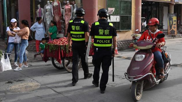 Police officers patrol in Kashgar. At state-backed mosques, religious activity is controlled as Beijing pursues a five-year plan to “Sinicise” Islam as the “only way for a healthy development of Islam” in the country, said Yang Faming, president of the state-backed Islamic Association of China, in January. (Greg Baker / AFP) Police officers patrol in Kashgar. At state-backed mosques, religious activity is controlled as Beijing pursues a five-year plan to “Sinicise” Islam as the “only way for a healthy development of Islam” in the country, said Yang Faming, president of the state-backed Islamic Association of China, in January. (Greg Baker / AFP)