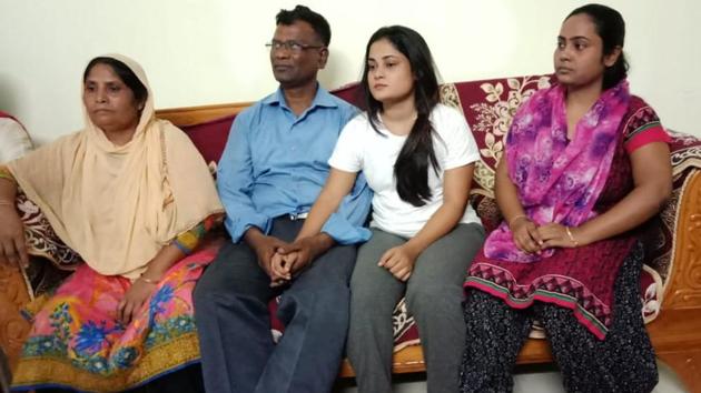 Mohammad Sanaullah (in blue shirt) with his wife Sanima Begun (extreme left) and two daughters at his home in Guwahati after his release from detention camp on Saturday.((HT Photo))