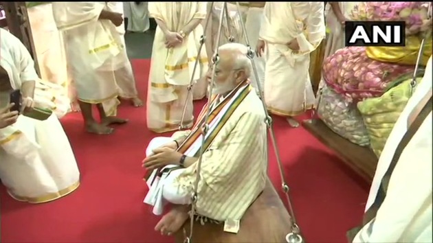 Prime Minister Narendra Modi being weighed with lotus flowers at the Sri Krishna Temple in Guruvayur in Kerala Saturday morning .(ANI)