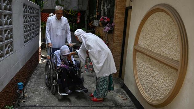 A Thai woman pays respect to an elderly woman on a wheelchair near Haroon mosque. Silk weaving boomed after World War II thanks to American “Silk King” Jim Thompson, who is credited with taking Thai silk global. Thompson’s house is one of the most visited tourist sites in Bangkok today, but it was across the canal in Baan Krua where he first found his suppliers among the Muslim weavers. (Romeo Gacad / AFP)