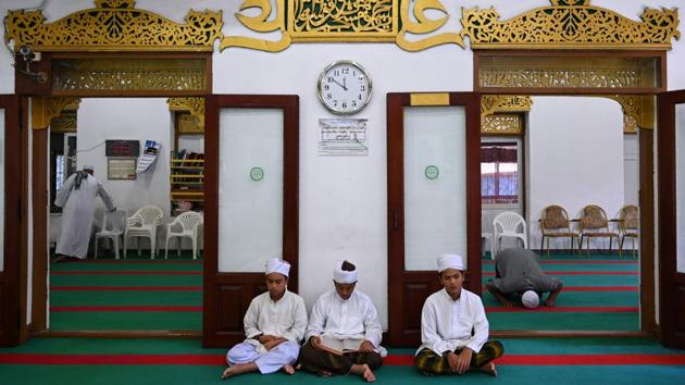 Young Thai boys read a copy of the holy Koran before Friday noon prayers at Haroon mosque in Bangkok. Though Thailand is overwhelmingly Buddhist, about seven million Muslims make up the country’s largest religious minority, and like the faithful everywhere they are observing Ramzan this month. (Romeo Gacad / AFP)