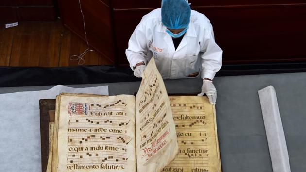 Bety Costales, restorer of Conservartecuador foundation, shows one of the polyglot bibles of the Fray Ignacio de Quezada library, at the Convent of Santo Domingo de Guzman, in Quito, Ecuador. (Rodrigo Buendia / AFP) Bety Costales, restorer of Conservartecuador foundation, shows one of the polyglot bibles of the Fray Ignacio de Quezada library, at the Convent of Santo Domingo de Guzman, in Quito, Ecuador. (Rodrigo Buendia / AFP)