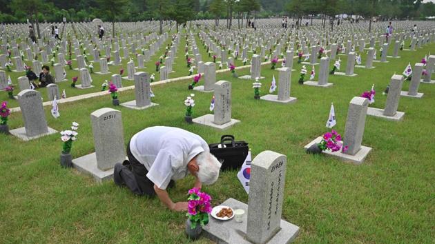 A South Korean man makes a deep bow as he visits the grave of his relative killed in the 1950-53 Korean Waron on the Korean Memorial Day, at the National Cemetery, in Seoul, South Korea. (Jung Yeon-je / AFP) A South Korean man makes a deep bow as he visits the grave of his relative killed in the 1950-53 Korean Waron on the Korean Memorial Day, at the National Cemetery, in Seoul, South Korea. (Jung Yeon-je / AFP)