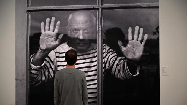 A man looks at a photograph by French photographer Robert Doisneau entitled "The Fate Line: Pablo Picasso at Vallauris, 1952." during the presentation of the photo-exhibition "Picasso, photographer's gaze", at the Picasso Museum, in Barcelona, Spain. (Lluis Gene / AFP) A man looks at a photograph by French photographer Robert Doisneau entitled "The Fate Line: Pablo Picasso at Vallauris, 1952." during the presentation of the photo-exhibition "Picasso, photographer's gaze", at the Picasso Museum, in Barcelona, Spain. (Lluis Gene / AFP)