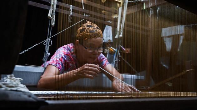 Rampai Sripetch, 65 -- weaves silk fabric on a loom at a workshop near Darul Falah mosque in Bangkok. There is a steady decline in apprentice weavers at silk shops, as modernity lures young Muslims away from a trade their community has dominated for generations. (Romeo Gacad / AFP)