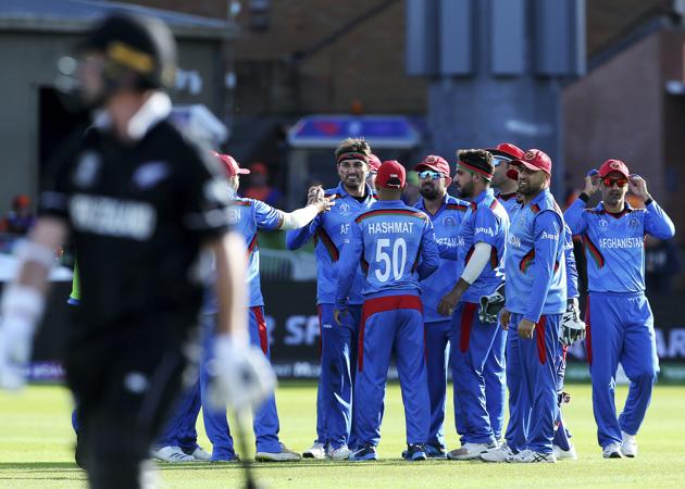 Afghanistan's Hamid Hassan celebrates catching New Zealand's Colin Munro with teammates during the ICC Cricket World Cup group stage match between Afghanistan and New Zeland, at the County Ground Taunton (AP)