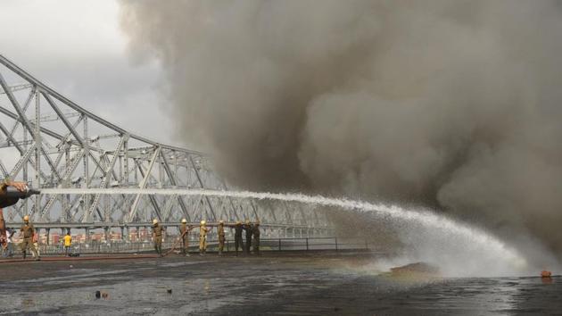 Firefighters try to douse a fire that broke out at a chemical godown near Howrah Bridge, adjacent to Jagannath Ghat, in Kolkata, West Bengal. (Samir Jana / HT Photo)