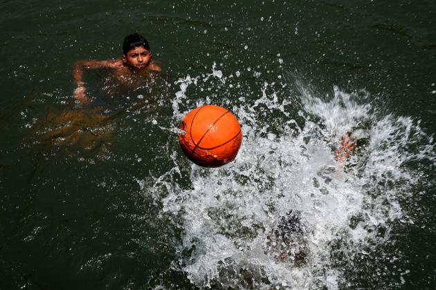 Children playing with ball in water taking relief from heat at Digha Dam Airoli in Navi Mumbai. (HTPhotos) Children playing with ball in water taking relief from heat at Digha Dam Airoli in Navi Mumbai. (HTPhotos)