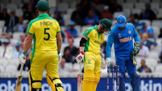 Australia's David Warner (C), Australia's captain Aaron Finch (L) and India's Mahendra Singh Dhoni look on after the ball touched his stumps but did not dislodge the bails during the 2019 Cricket World Cup group stage match between India and Australia at The Oval in London on June 9, 2019(AFP)