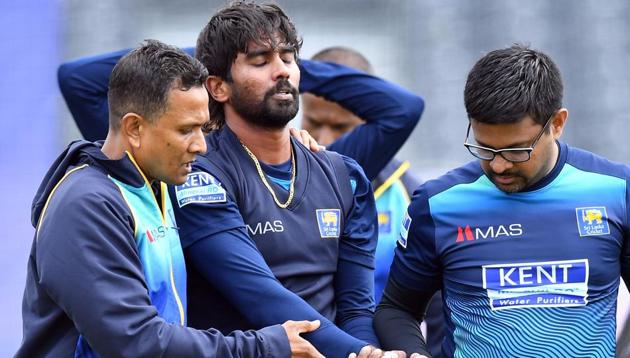 Sri Lanka's Nuwan Pradeep (C) walks off the field for medical treatment as he gets injured during a training session. (AFP) Sri Lanka's Nuwan Pradeep (C) walks off the field for medical treatment as he gets injured during a training session. (AFP)