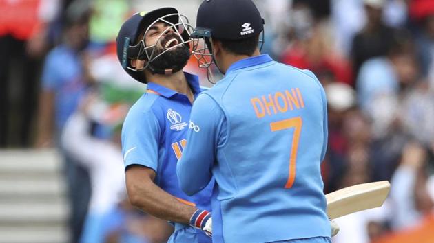 India's captain Virat Kohli celebrates with teammate MS Dhoni. (AP)