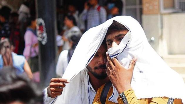 People cover their faces with pieces of cloth and scarves to beat the heat on a summer day, in Gurugram, India, on Monday, June 10, 2019.((Photo by Yogendra Kumar/Hindustan Times))