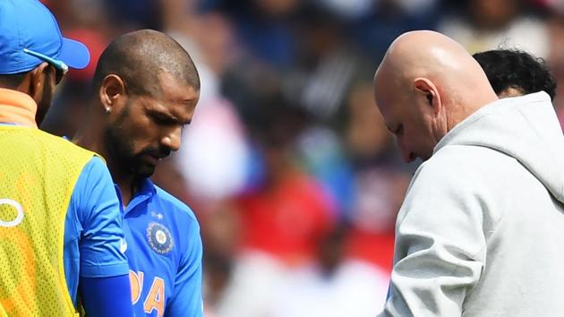 India's Shikhar Dhawan (2L) receives medical treatment after being hit on the hand with a ball whilst batting during the 2019 Cricket World Cup group stage match between India and Australia at The Oval.(AFP)