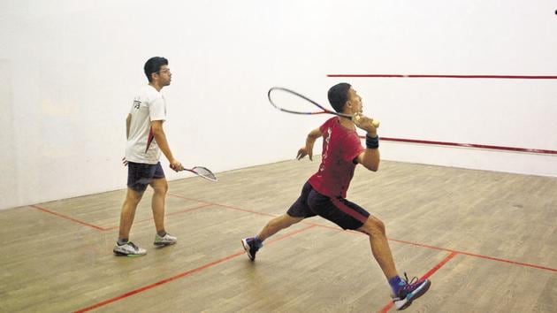 Veer Chotrani (white t-shirt),and Kunal Singh (maroon t-shirt) in action during the national level squash tournament at the RSI squash court in Pune on Monday. (Shankar Narayan/HT PHOTO) Veer Chotrani (white t-shirt),and Kunal Singh (maroon t-shirt) in action during the national level squash tournament at the RSI squash court in Pune on Monday. (Shankar Narayan/HT PHOTO)