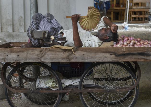 A vegetable seller takes rest on cart as the Chennai city reels under a heat wave on June 10, 2019. Heatwave conditions in the national capital are set to end on Tuesday following rains in the evening, bringing much needed respite from the scorching heat. According to the India Meteorological Department, light rains are expected in the evening owing to a cyclonic circulation over Rajasthan and moisture-laden winds from the Arabian sea. (PTI) A vegetable seller takes rest on cart as the Chennai city reels under a heat wave on June 10, 2019. Heatwave conditions in the national capital are set to end on Tuesday following rains in the evening, bringing much needed respite from the scorching heat. According to the India Meteorological Department, light rains are expected in the evening owing to a cyclonic circulation over Rajasthan and moisture-laden winds from the Arabian sea. (PTI)