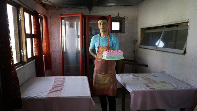 Inmate Nelson Avantti, holds a cake at his bakery inside the Punta de Rieles prison. Of the 510 prisoners, who include thieves, assailants, kidnappers and killers, 382 work and 246 study — some do both. Only a few dozen have shunned those opportunities, and if two years pass, they will be transferred to a traditional prison. To get chosen for Punta de Rieles, prisoners have to have at least a six-month period of good behaviour elsewhere. (Matilde Campodonico / AP)