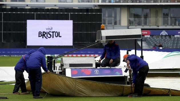 Ground staff adjust the rain covers at the ICC Cricket World Cup group stage match at the County Ground in Bristol. England, Tuesday June 11, 2019. Bangladesh is scheduled to play Sri Lanka Tuesday but there has not been any play yet, as much of England is suffering from unseasonal downpours(AP)