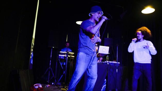 Inmate Federico Gonzalez (L), a musician also known as Kung-Fu OmBijam, performs at La Cretina pub during a Hip Hop festival in Montevideo. Gonzalez is allowed to leave the grounds to perform as part of a program designed to rehabilitate the inmates of the prison. Money to start businesses comes from inmates’ families or from a quasi-bank largely administered by inmates themselves. (Matilde Campodonico / AP)