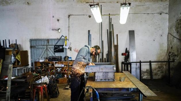 Former inmate Mauro Rodríguez works at the blacksmith shop at the Punta de Rieles prison in Montevideo, Uruguay. The Punta de Rieles project began in late 2012, with Parodi as deputy director, and he took over as head of the prison in 2015. The bet is that prisoners who work, study, learn a craft or start a business will have a better life and be less likely to return to crime. (Matilde Campodonico / AP)