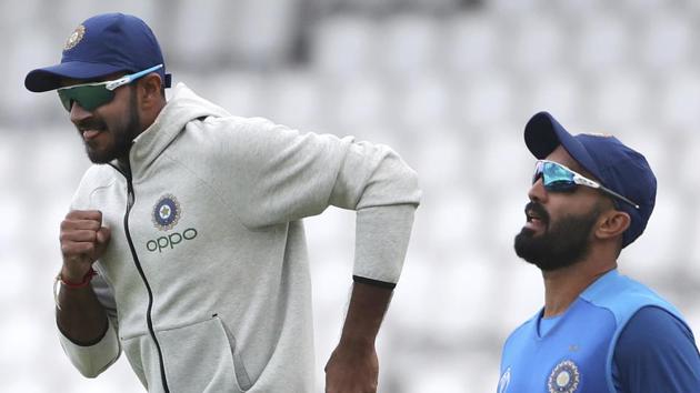 India's Vijay Shankar, left, and Dinesh Karthik warm up during a training session.(AP)