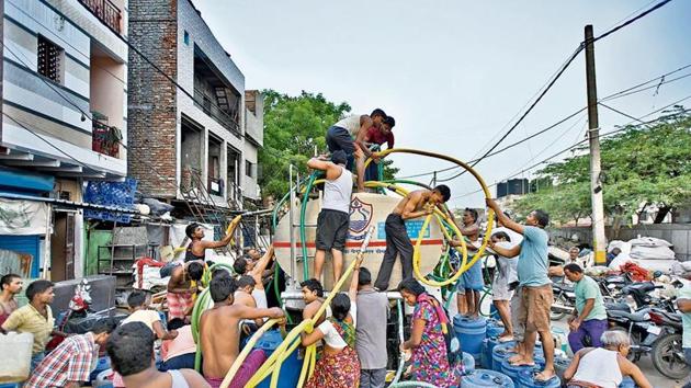 People fill their empty containers with water using lengths of hose pipe from a Delhi Jal Board tanker, at Sanjay Colony in Okhla Phase II, in New Delhi, India, on Wednesday, June 12, 2019. ((Photo by Burhaan Kinu/ Hindustan Times)) People fill their empty containers with water using lengths of hose pipe from a Delhi Jal Board tanker, at Sanjay Colony in Okhla Phase II, in New Delhi, India, on Wednesday, June 12, 2019. ((Photo by Burhaan Kinu/ Hindustan Times))