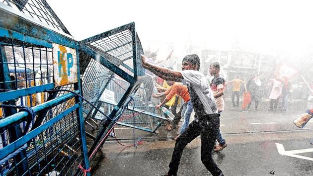 Supporters of India’s Bharatiya Janata Party (BJP) break barricades as police use water cannon to disperse them during a protest against what they call violence against their party workers in the state of West Bengal, in Kolkata (Reuters) Supporters of India’s Bharatiya Janata Party (BJP) break barricades as police use water cannon to disperse them during a protest against what they call violence against their party workers in the state of West Bengal, in Kolkata (Reuters)