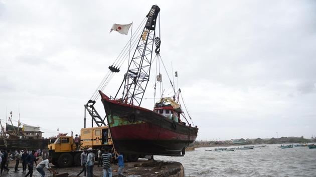 Fishermen lift a boat out of the sea as a part of precautionary measures as Cyclone Vayu nears the coastline at Veraval Port. Veraval is a major hub of India’s fisheries industry exporting to Japan, South East Asia, Europe, the Gulf and the United States. All ports in the state of Gujarat have stopped accommodating berths for ships starting Wednesday. Gujarat is home to two other major ports--Deendayal and Adani in the Gulf of Kutch. (Sam Panthaky / AFP) Fishermen lift a boat out of the sea as a part of precautionary measures as Cyclone Vayu nears the coastline at Veraval Port. Veraval is a major hub of India’s fisheries industry exporting to Japan, South East Asia, Europe, the Gulf and the United States. All ports in the state of Gujarat have stopped accommodating berths for ships starting Wednesday. Gujarat is home to two other major ports--Deendayal and Adani in the Gulf of Kutch. (Sam Panthaky / AFP)