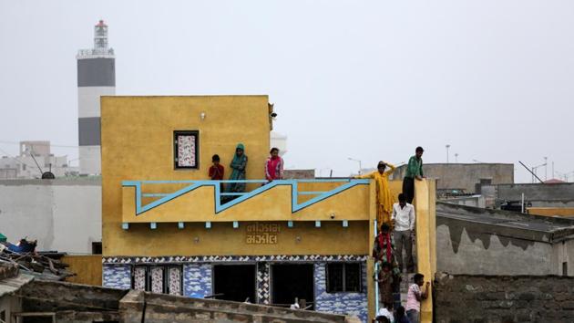 Residents watch high waves from their house ahead of Cyclone Vayu in Veraval. Operations at airports in Porbandar, Diu, Bhavnagar, Keshod and Kandla are ceased till Thursday midnight. The railways has cancelled 77 trains and short terminated 33 others. (Amit Dave / REUTERS) Residents watch high waves from their house ahead of Cyclone Vayu in Veraval. Operations at airports in Porbandar, Diu, Bhavnagar, Keshod and Kandla are ceased till Thursday midnight. The railways has cancelled 77 trains and short terminated 33 others. (Amit Dave / REUTERS)