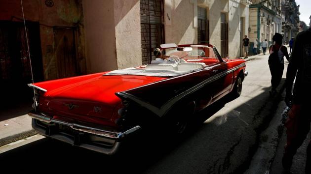 A private taxi driver in an empty old American car drives along a street of Havana waiting for tourists to flag him down. Earlier this month, the US Treasury Department banned group educational travel as well as cruise ship and private yacht visits by Americans to Cuba, linking the action to Havana's backing of Venezuela's President Nicolas Maduro. (Yamil Lage / AFP)