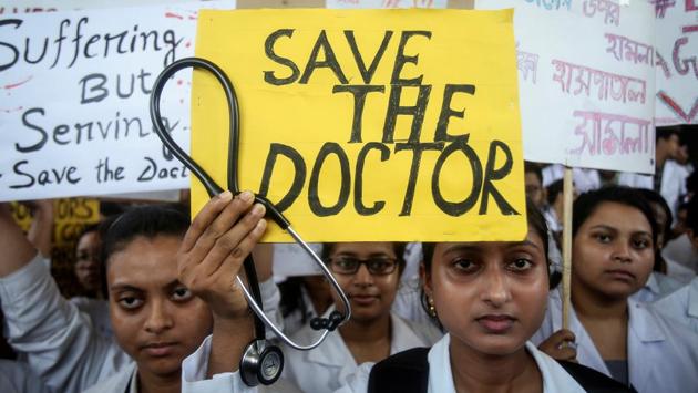 A doctor holds a placard at a government hospital during a strike demanding security after the recent assaults on doctors by the patients' relatives, in Agartala. The India Medical Association has declared “All India Protest Day” on Friday against the incident and expressed solidarity with the striking doctors. Doctors in some parts of the country including Delhi’s AIIMS and Mumbai’s JJ Hospital have also come out in support of their striking colleagues in Bengal. (Jayanta Dey / REUTERS) A doctor holds a placard at a government hospital during a strike demanding security after the recent assaults on doctors by the patients' relatives, in Agartala. The India Medical Association has declared “All India Protest Day” on Friday against the incident and expressed solidarity with the striking doctors. Doctors in some parts of the country including Delhi’s AIIMS and Mumbai’s JJ Hospital have also come out in support of their striking colleagues in Bengal. (Jayanta Dey / REUTERS)