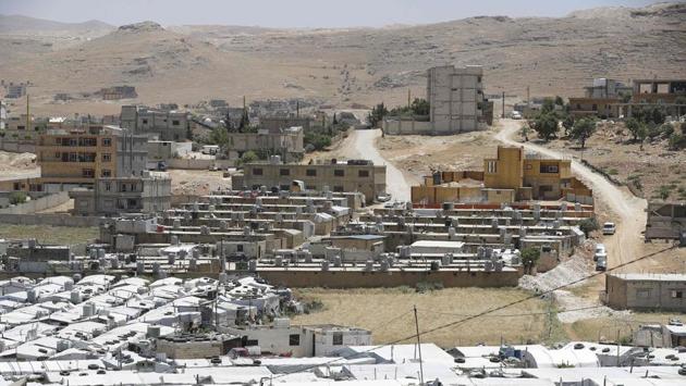 Syrian refugee camp seen in the northeastern town of Arsal. Lebanese politicians and part of the population have called for Syrian refugees to go home, blaming them for a string of economic woes in the country. Rights groups, including Amnesty International, have warned that Lebanon is using restrictive measures such as evictions, curfews and raids to encourage repatriation. (Joseph Eid / AFP)