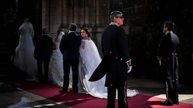 Brides and their best-men queue to enter the cathedral ahead of the celebration of a multiple wedding ceremony in Lisbon, Portugal. It is Lisbon’s wedding of the year. Not one, but 11 couples walked out, fresh from tying the knot in an all expenses paid ceremony, the beneficiaries of a decades long annual tradition that fetes the Portuguese capital’s beloved patron Saint Anthony. (Patricia De Melo Moreira / AFP)