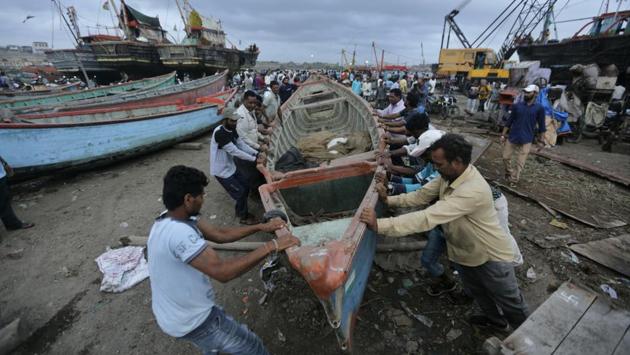 People move a fishing boat to a safer ground on the Arabian Sea coast in Veraval, Gujarat. The authorities evacuated tens of thousands of people as a severe cyclone in the Arabian Sea approached the western state of Gujarat, lashing the coast with high winds and heavy rainfall. (Ajit Solanki / AP)