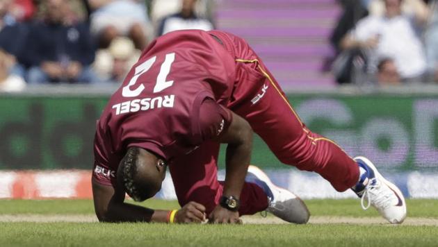 West Indies' Andre Russell gets up before walking off the field of play with an injury after bowling during the Cricket World Cup match between England and West Indies(AP) West Indies' Andre Russell gets up before walking off the field of play with an injury after bowling during the Cricket World Cup match between England and West Indies(AP)