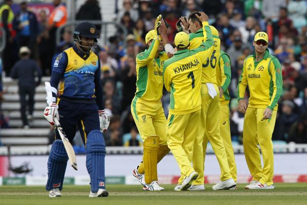 Australia's Mitchell Starc (C) celebrates with teammates after taking the wicket of Sri Lanka's Milinda Siriwardana (L). (AFP)