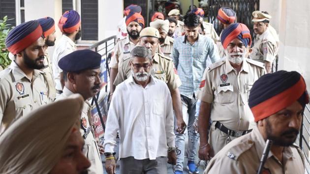 Sanji Ram and Parvesh Kumar, convicted in the Kathua rape and murder case, leave the District Court after it sentenced them to prison terms at Pathankot in Punjab. Six men were found guilty by the court. (Sameer Sehgal / HT Photo)