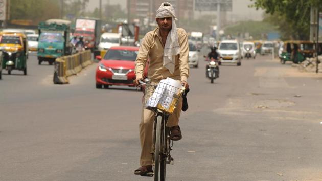Om Veer Sharma is a postman who travels close to 40 km a day on his bicycle to deliver mail. He said he leaves the Sadar Bazaar post office at around 9 am for sectors 15, 30, 31 and nearby areas. All mail is usually delivered by 5:30 pm. For Sharma, cycling long distances isn’t easy. However, he said he takes frequent breaks. “People also offer me water and snacks; so that keeps me going,” he said. (Parveen Kumar / HT Photo)