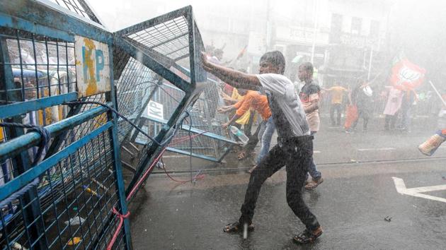 Supporters of India’s Bharatiya Janata Party (BJP) break barricades as police use water cannon to disperse them during a protest against what they call violence against their party workers in their state, in Kolkata, West Bengal. (Rupak De Chowdhuri / REUTERS)