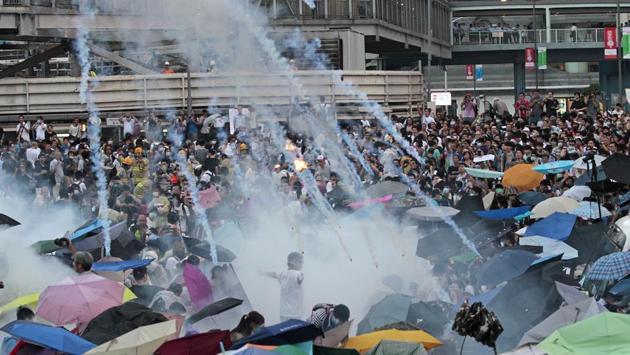 September 28, 2014: Riot police launched tear gas into the crowd as thousands of protesters surrounded the government headquarters in Hong Kong. A series of steps by the Chinese and Hong Kong governments in recent years have prompted a growing uneasiness among Hong Kong residents about their future. Protesters seeking direct elections for Hong Kong’s leader laid siege to government headquarters for 79 days but fail to win any concessions. (Wally Santana / AP File)