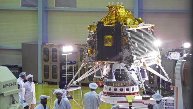 Scientists and employees view the Chandrayaan-2 spacecraft Lander module at the Indian Space Research Organization Satellite Integration and Test Establishment (ISITE) at the ISRO headquarters in Bengaluru, Karnataka. India will launch a lunar mission on July 15, attempting to become the fourth country to land on the moon and cementing its place among the world's space faring nations. (Karen Dias / Bloomberg)