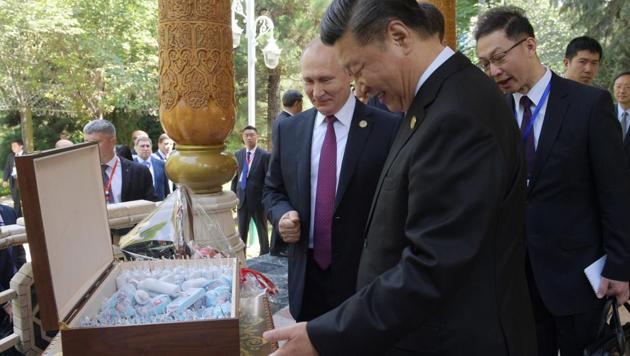 Russian President Vladimir Putin presented his Chinese counterpart Xi Jinping with a giant box of ice cream for his 66th birthday before a summit in Tajikistan on Saturday (AFP) Russian President Vladimir Putin presented his Chinese counterpart Xi Jinping with a giant box of ice cream for his 66th birthday before a summit in Tajikistan on Saturday (AFP)