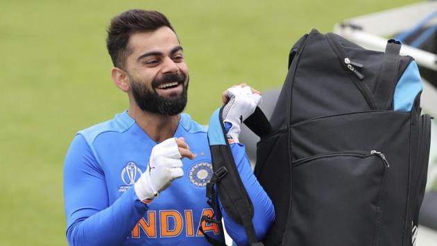India's captain Virat Kohli lifts his kit before proceeding for batting in the nets during a training session ahead of their Cricket World Cup match against Pakistan at Old Trafford in Manchester(AP)
